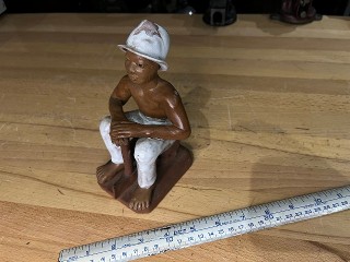 Black African man with axe clay glazes statue Black African man with axe clay glazes statue